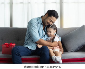 Handsome Asian Dad Giving Cute Daughter A Big Hug Afther Getting Gift For Speicial Day. Father's Day Or Birthday Concept.