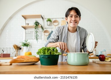 Handsome Asian Man Prepares Breakfast After All The Ingredients Are Cooked In The Kitchen. Health Care Concept And Eating Healthy Food. Good Skin And Good Health