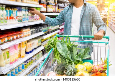 Handsome asian man shopping in a supermarket. shopping concept