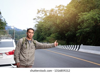 Handsome Asian Man Wave Hand Or Thumb Up For Take A Car, People Lifestyle In Holiday 