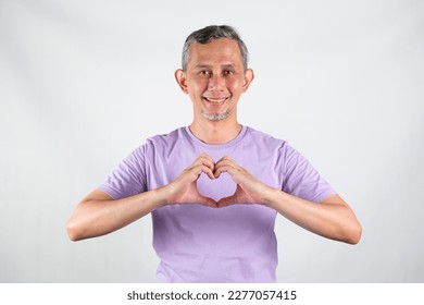 Handsome Asian man wearing red tshirt smiling with love sign (heart with fingers) on his chest, health concept.
 - Shutterstock ID 2277057415