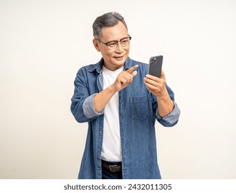 Handsome asian mature old man standing using smartphone on isolated white background. Happy Portrait of cheerful smiling senior asian man holding cell phone. Mature People and lifestyle - Powered by Shutterstock