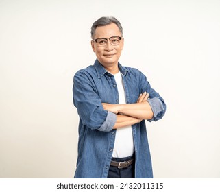 Handsome asian mature old man standing arm crossed on isolated white background. Happy Portrait of cheerful smiling senior asian man looking at camera. Mature People and lifestyle - Powered by Shutterstock