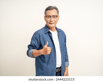 Handsome asian mature old man standing thumbs up on isolated white background. Happy Portrait of cheerful smiling senior asian man looking at camera. Mature People and lifestyle - Powered by Shutterstock