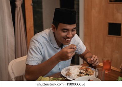 Handsome Asian Young Muslim Man Eating Dinner With Family