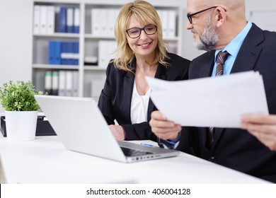 Handsome Bald Business Man With Beard And Eyeglasses Showing Woman Something