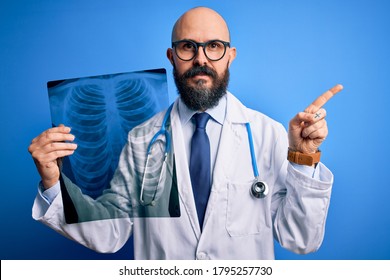 Handsome Bald Doctor Man With Beard Wearing Stethoscope Holding Chest Xray Very Happy Pointing With Hand And Finger To The Side