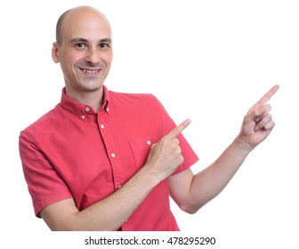 Handsome Bald Man In Red Shirt Pointing To Copy Space. Isolated On White