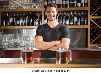 Handsome Bar Tender Standing Behind His Counter In A Pub