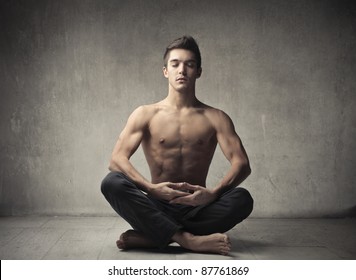 Handsome bare-chested man doing yoga