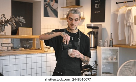 Handsome barista guy work coffee shop. Tattooed hipster man portrait. Happy male face smile. Joy young adult person look camera at cozy cafe house. Stylish dyed hair waiter make hot tasty drink order. - Powered by Shutterstock