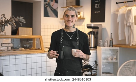 Handsome barista guy work coffee shop. Tattooed hipster man portrait. Happy male face smile. Joy young adult person look camera at cozy cafe house. Stylish dyed hair waiter make hot tasty drink order. - Powered by Shutterstock