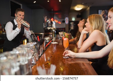 Handsome Bartender Making Cocktails For Beautiful Women In A Classy Bar