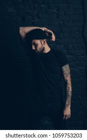 Handsome beard man posing in the studio, Hands close up of young tattooed man portrait in Shoreditch borough, London. Hipster style, brutal hipster, 