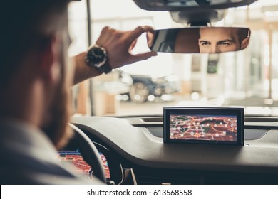 Handsome Bearded Businessman Is Looking Into The Rear View Mirror While Driving The Car