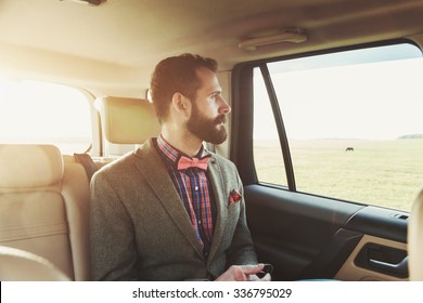 Handsome Bearded Businessman Sitting On Back Seat Of Car