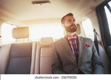 Handsome Bearded Businessman Sitting On Back Seat Of Car