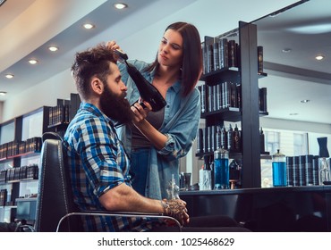 Handsome bearded man in the barbershop. - Shutterstock ID 1025468629