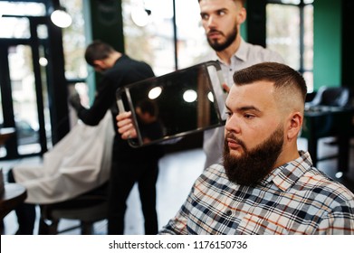 Handsome bearded man at the barbershop, barber at work. - Shutterstock ID 1176150736