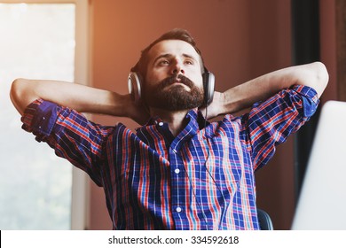 handsome bearded man  in headphones listening to music - Shutterstock ID 334592618