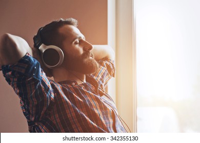 handsome bearded man  in headphones listening to music - Shutterstock ID 342355130