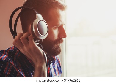 handsome bearded man  in headphones listening to music - Shutterstock ID 347962961