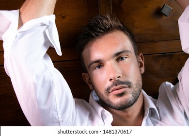 Handsome Bearded Man With Open Shirt Revealing Hairy Chest Looking At Camera