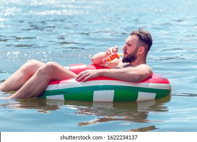 handsome bearded man in a pool on a round air mattress drinks a drink from a glass goblet