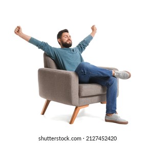 Handsome bearded man stretching in grey armchair on white background - Shutterstock ID 2127452420