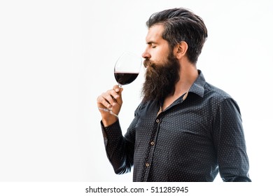Handsome Bearded Rich Man With Stylish Hair Mustache And Long Beard On Serious Face In Blue Fashion Shirt Holding Glass And Sniff Smell Of Red Wine Isolated On White