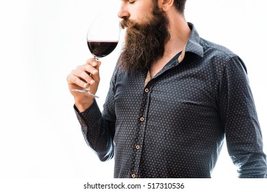 Handsome Bearded Rich Man With Stylish Mustache And Long Beard On Serious Face In Blue Fashion Shirt Holding Glass And Sniff Smell Of Red Wine Isolated On White