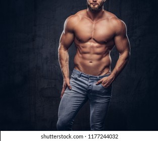 Handsome Bearded Sporty Guy With A Muscular Body In Jeans Posing In Studio.