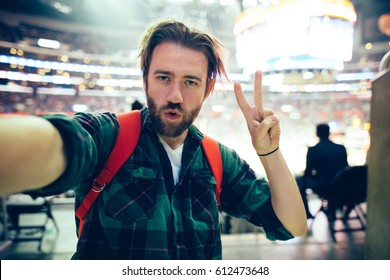 Handsome Bearded Supporter Watching Basketball Game And Making Selfie Self-portrait With Smartphone At Stadium