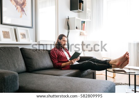 Similar – Image, Stock Photo Young man relaxing on the sofa with a laptop