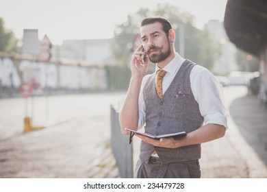 handsome big moustache hipster man with diary and smartphone in the city - Powered by Shutterstock