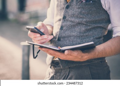 Handsome Big Moustache Hipster Man With Diary And Smartphone In The City