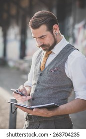 Handsome Big Moustache Hipster Man With Diary And Smartphone In The City