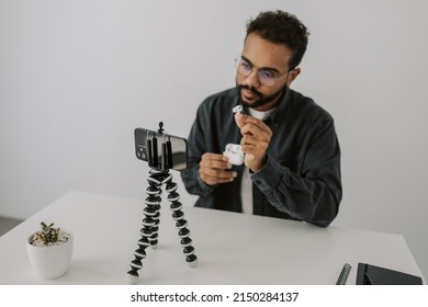 Handsome Black Man Vlogger Sitting In Living Room And Talking To Phone Camera