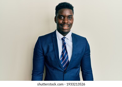 Handsome Black Man Wearing Business Suit And Tie With A Happy And Cool Smile On Face. Lucky Person. 