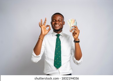 Handsome Black Millennial Businessman Holding Money And Making Quality Sign On A Studio Background-concept On Africans And Business