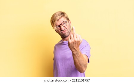 Handsome Blond Adult Man Feeling Angry, Annoyed, Rebellious And Aggressive, Flipping The Middle Finger, Fighting Back