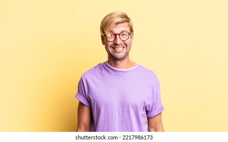 Handsome Blond Adult Man Looking Happy And Pleasantly Surprised, Excited With A Fascinated And Shocked Expression