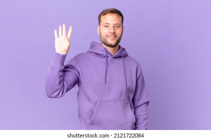 Handsome Blonde Man Smiling Happily, Waving Hand, Welcoming And Greeting You