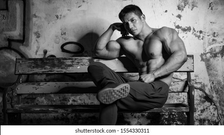 Handsome Body Builder Sit On The Chair.