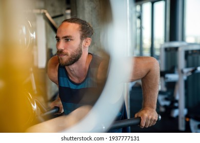 Handsome bodybuilder man works out and excercise in gym