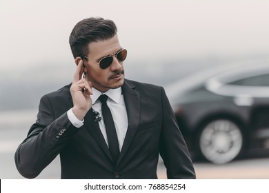 Handsome Bodyguard Listening Message With Security Earpiece 