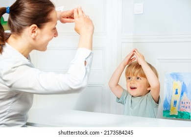 Handsome Boy In Development Finger Game Class With Therapist Setting Example Sitting By The Desk