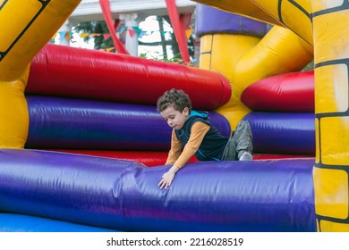 handsome boy playing in bouncy castle - Shutterstock ID 2216028519