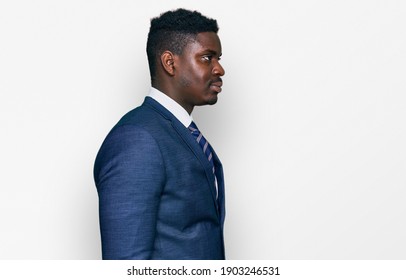 Handsome Business Black Man Wearing Business Suit And Tie Looking To Side, Relax Profile Pose With Natural Face With Confident Smile. 