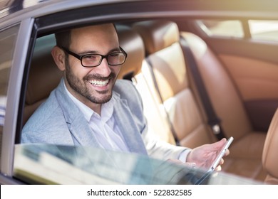 Handsome business man in car.
